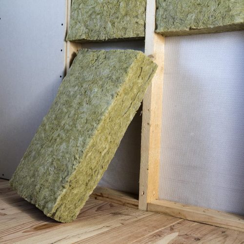 Wooden frame for future walls with drywall plates insulated with rock wool and fiberglass insulation staff for cold barrier. Comfortable warm home, economy, construction and renovation concept.